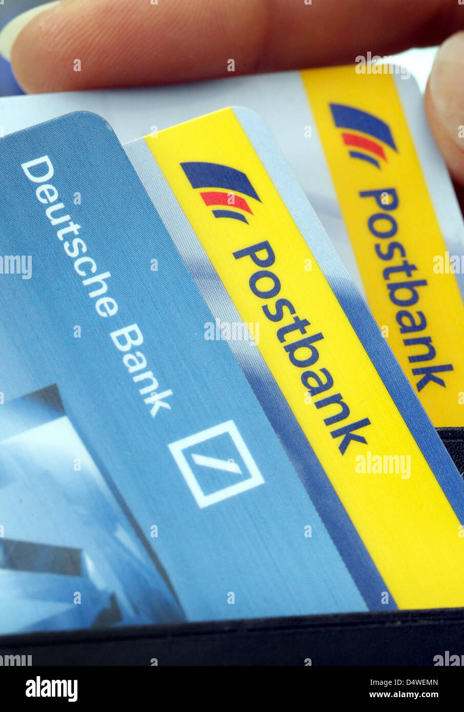 A file picture taken on 11 September 2008 shows Deutsche Bank and Postbank  cash cards in Duesseldorf, Germany. Deutsche Bank take over the majority of  Postbank shares. The bank had been offered