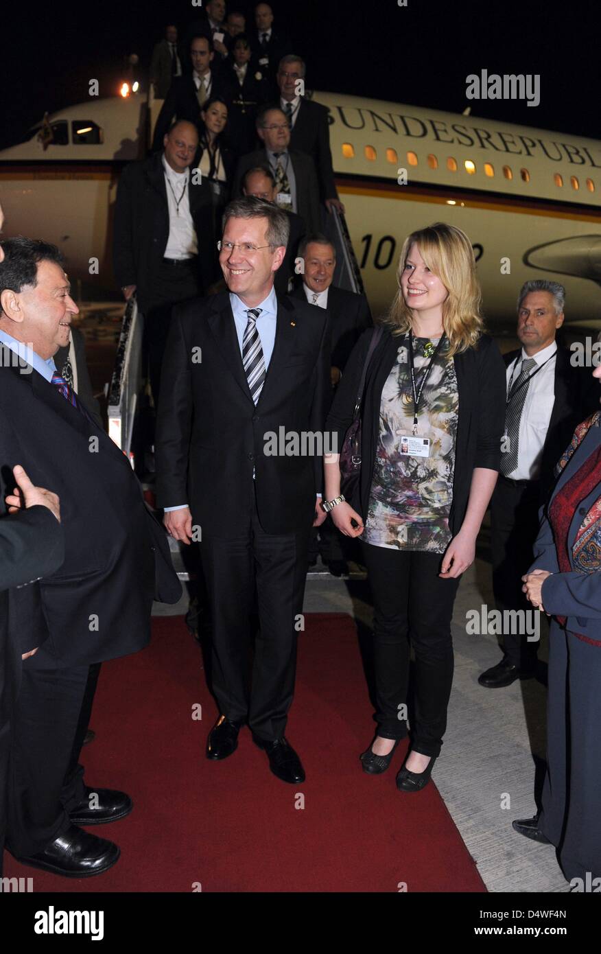 German President Christian Wulff and daughter Annalena are welcomed by Israel's Minister of Industry, Trade and Labour, Binyamin Ben-Eliezer, (L) in Tel Aviv, Israel, 27 November 2010. Wulff's 17-year-old daughter accompanies Mr Wulff on his four-day visit to Israel in stead of his wife Bettina. The choice of travel companion is supposed to symbolize the importance of transmitting  Stock Photo