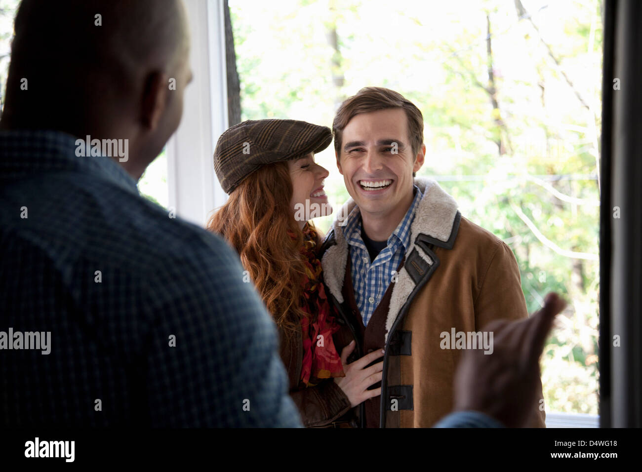Smiling couple at front door Stock Photo - Alamy
