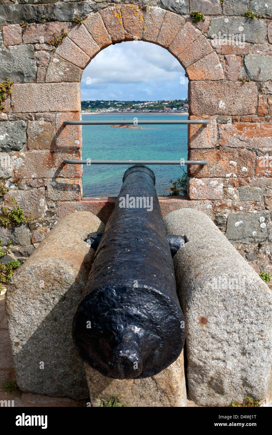 A canon at Elizabeth Castle aimed over St Aubin's Bay , St Helier