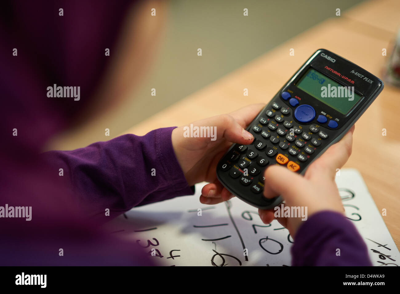 calculator calculate maths school lesson education arithmetic adding fiscal  boy young Stock Photo - Alamy