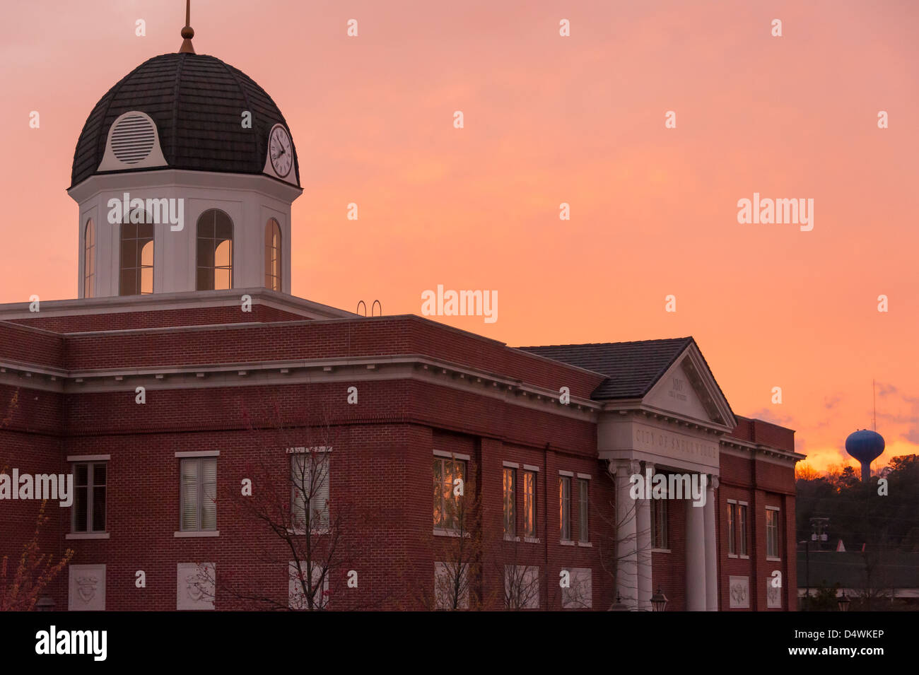 The orange glow of sunset bathes the Snellville City Hall building with the last light of evening in Snellville, Georgia, USA. Stock Photo