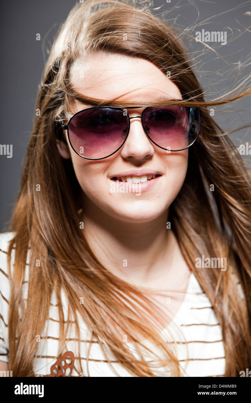 Pretty teenage girl with sunglasses. Studio shot Stock Photo Alamy