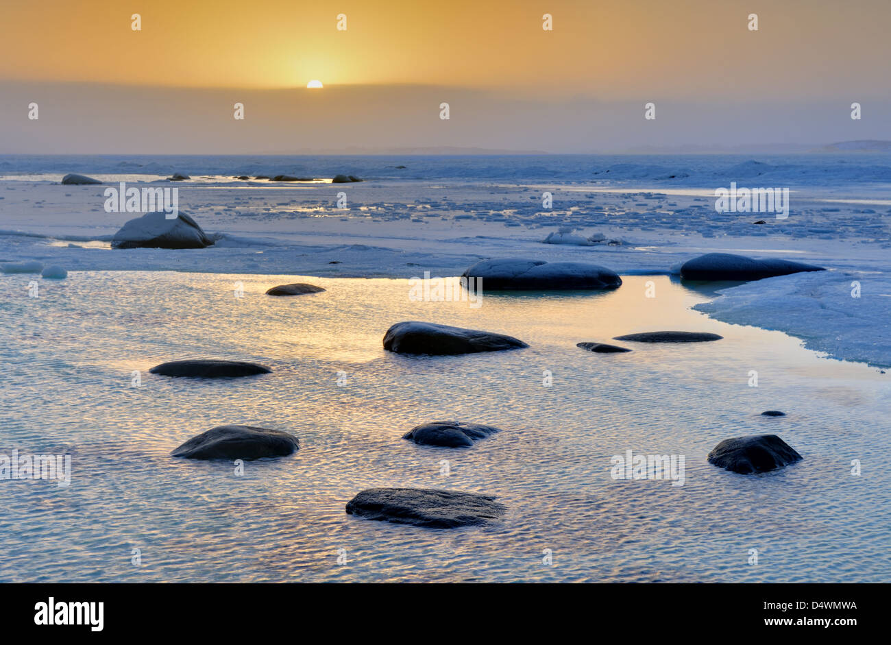 Frozen water and rocks on the coast of Näsbokrok Nature reserve at sunrise, Halland, Sweden, Europe Stock Photo