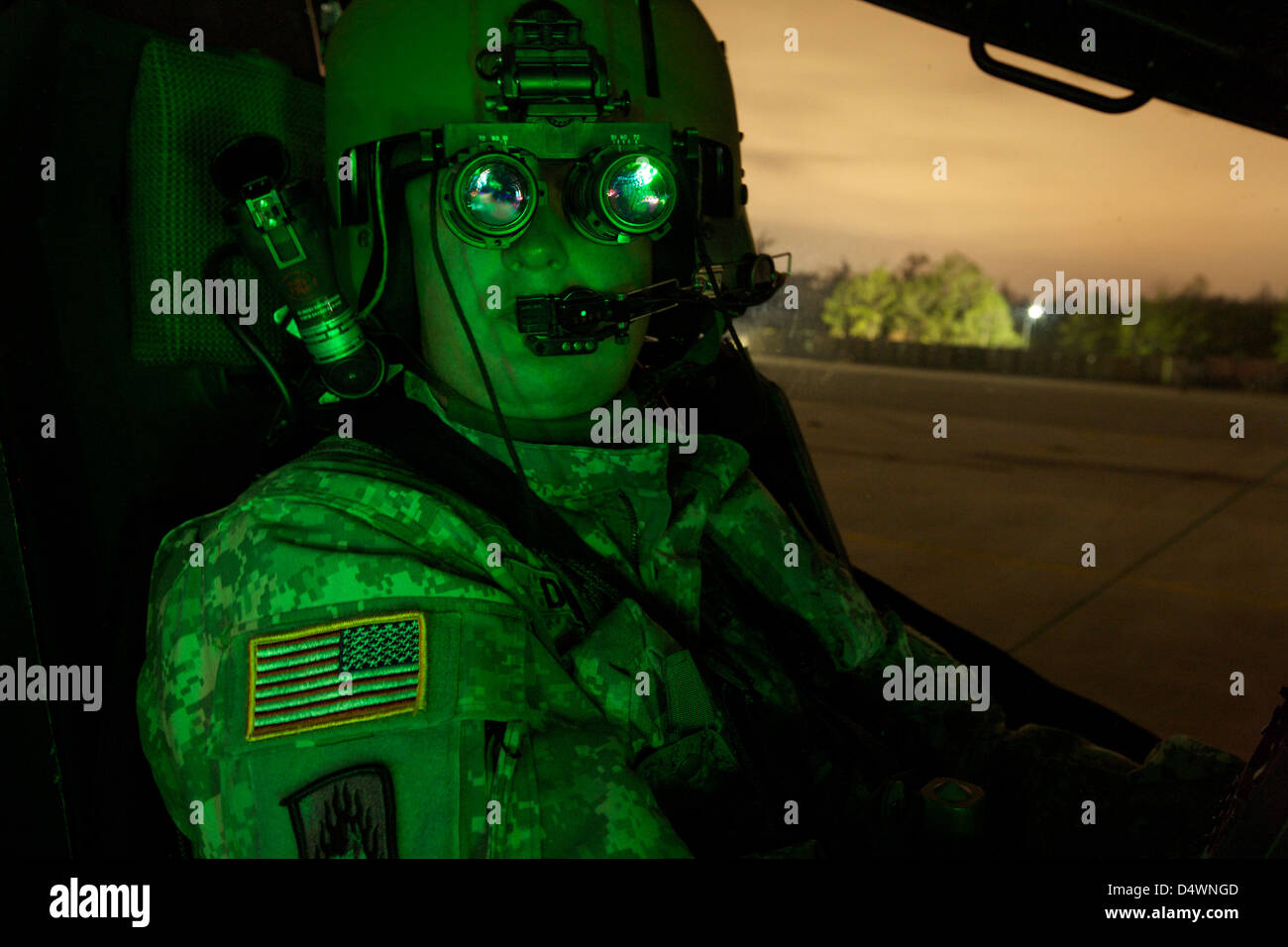 A pilot equipped with night vision goggles in the cockpit 