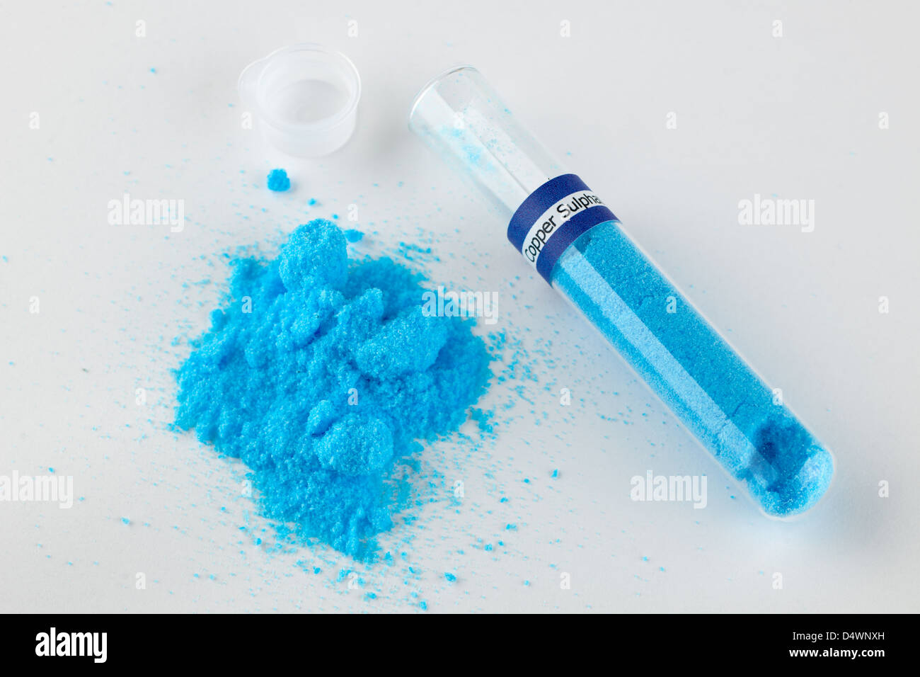 Pile of Copper Sulphate CuSO4*5H2O chemical  and test tube Stock Photo