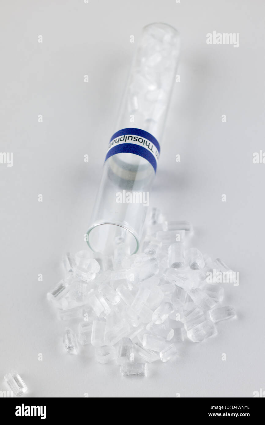 Test tube spilling Sodium thiosulphate Na2S2O3 colourless crystals Stock Photo
