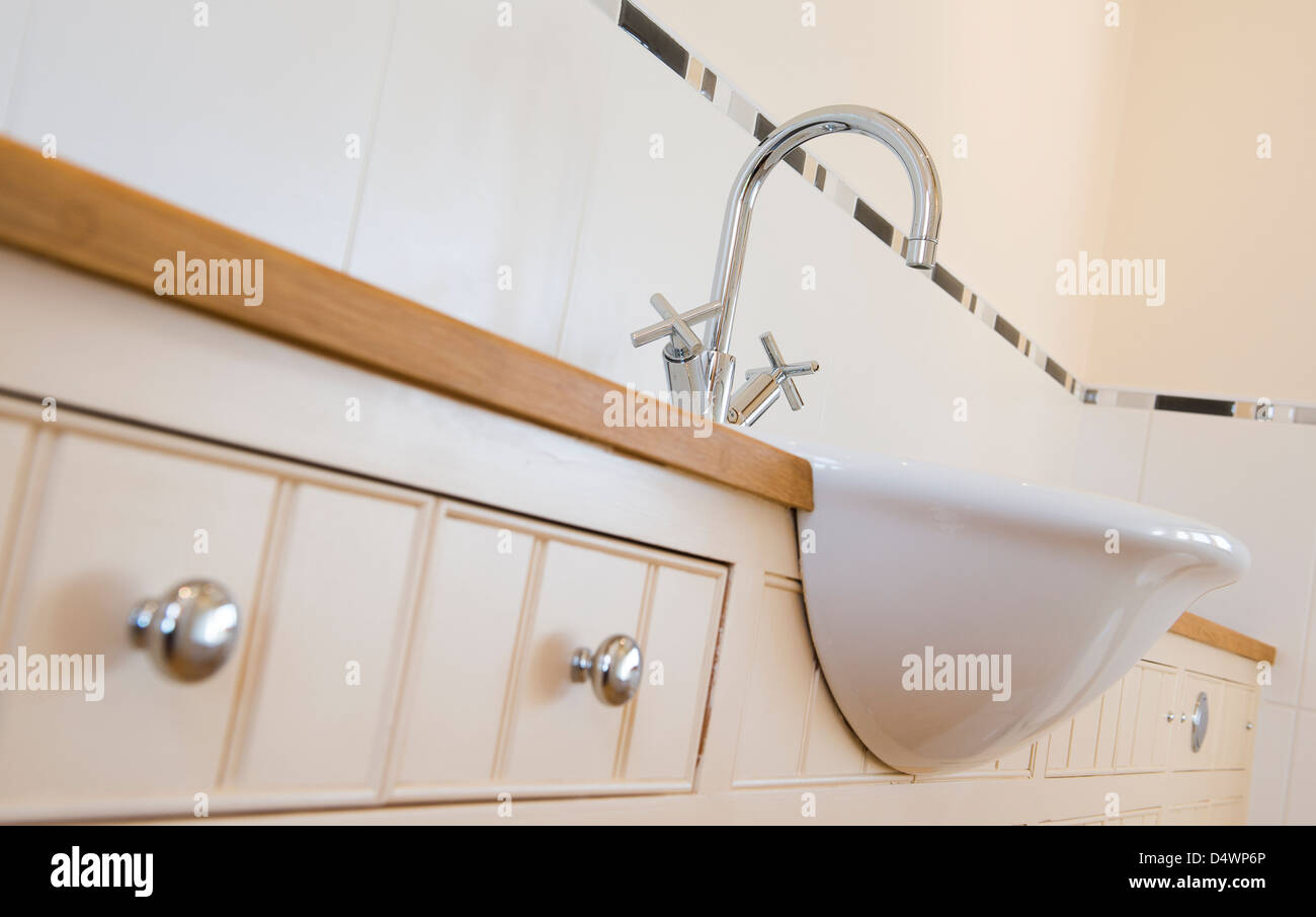 Close up of a sink and taps in a newly decorated bathroom Stock Photo