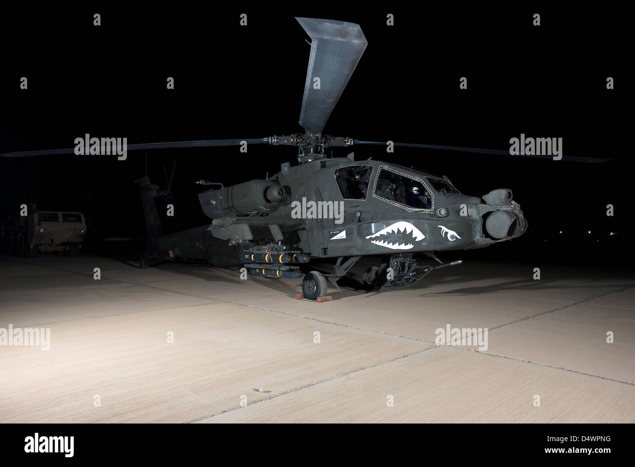 An AH-64D Apache Longbow at night, Tikrit, Iraq. Stock Photo
