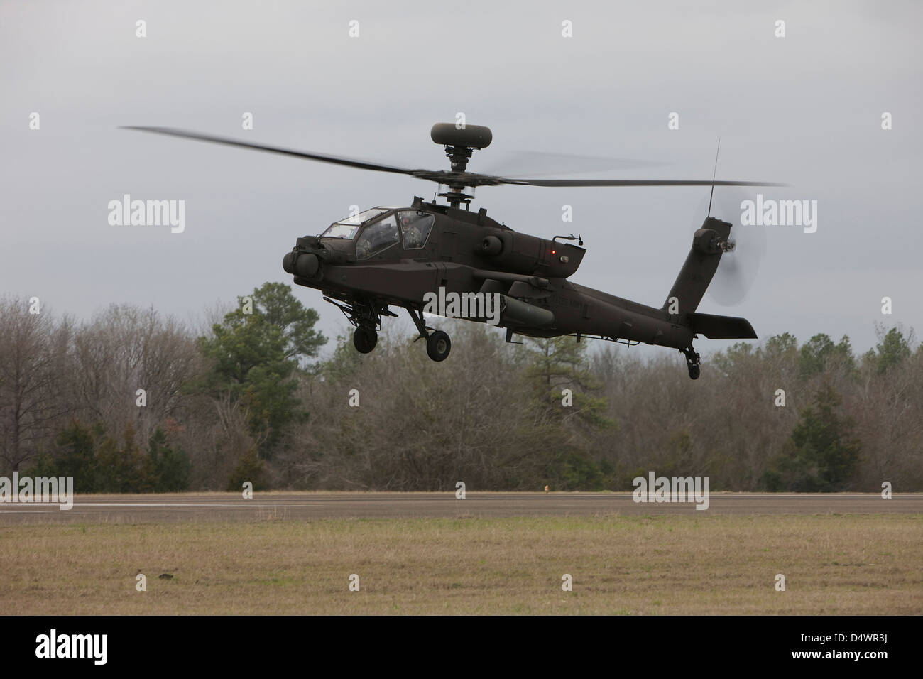 An AH-64 Apache helicopter in midair, Conroe, Texas. Stock Photo