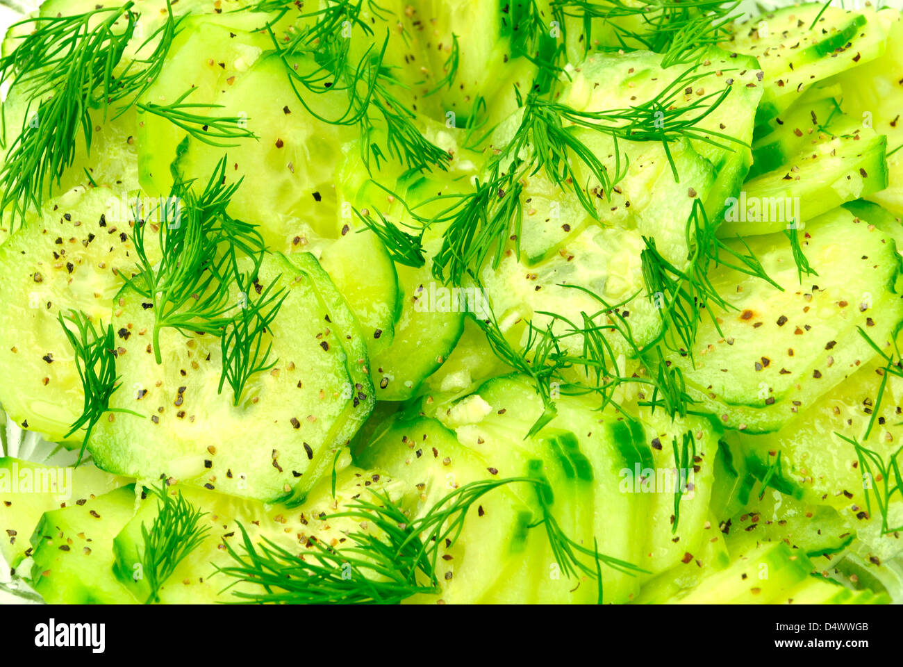 closeup of fresh cucumber and dill salad garnished with olive oil pepper and salt Stock Photo
