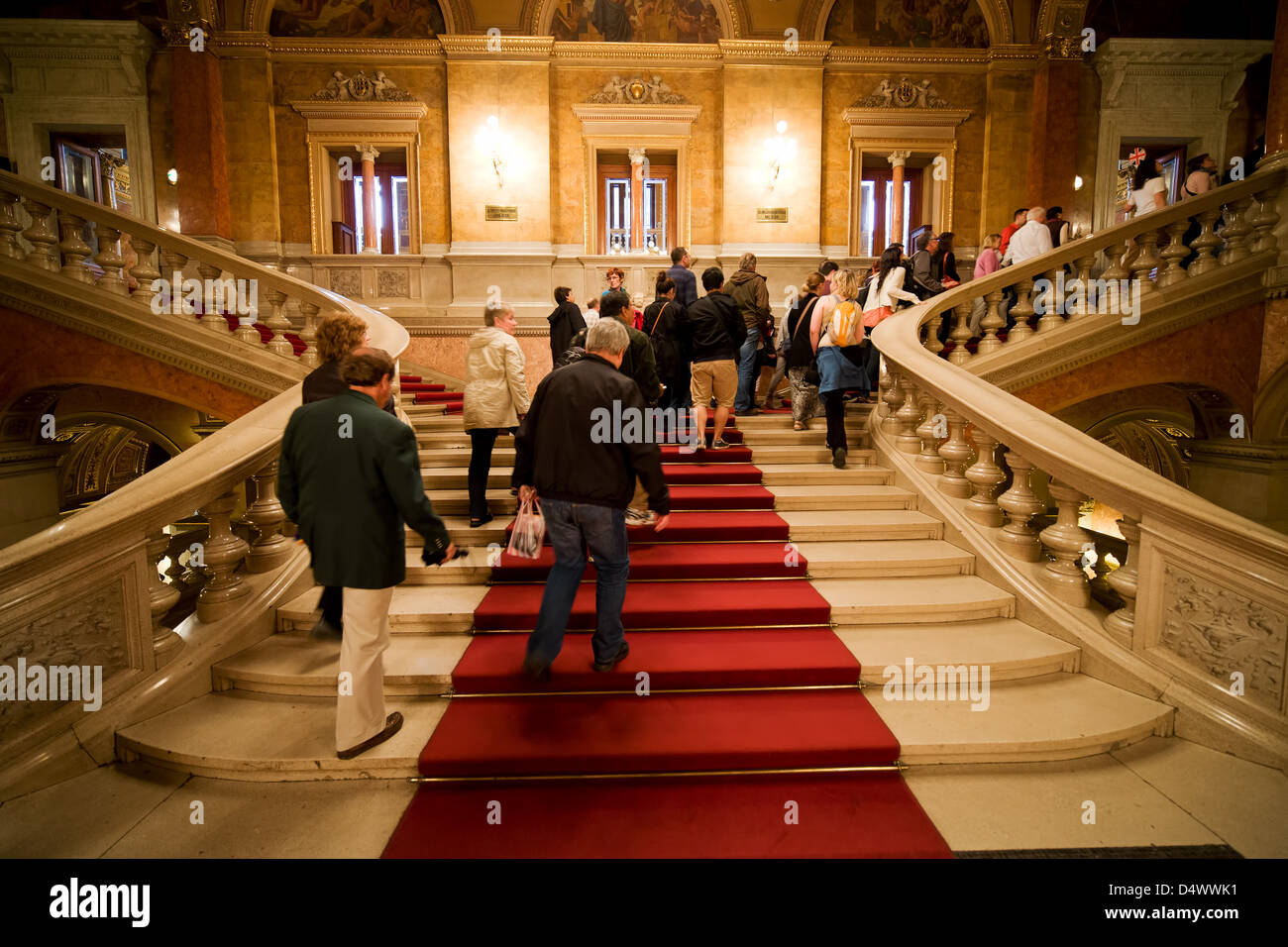 Budapest Opera House main staircase interior in Hungary, group of tourists on tour climbing the