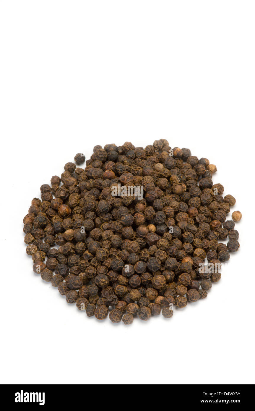 Black peppercorns on white Stock Photo