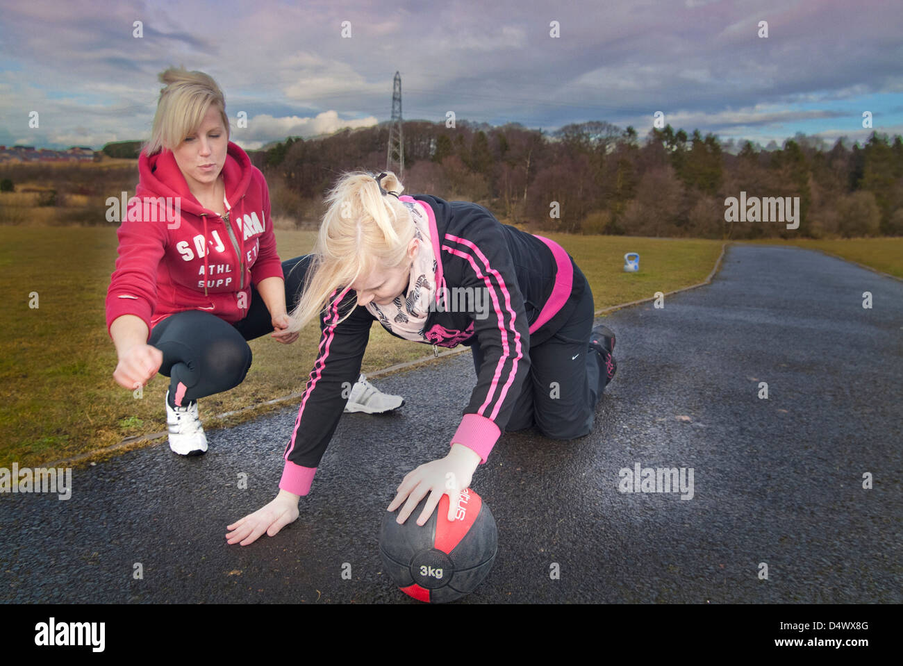 Personal Trainer helping a client Stock Photo