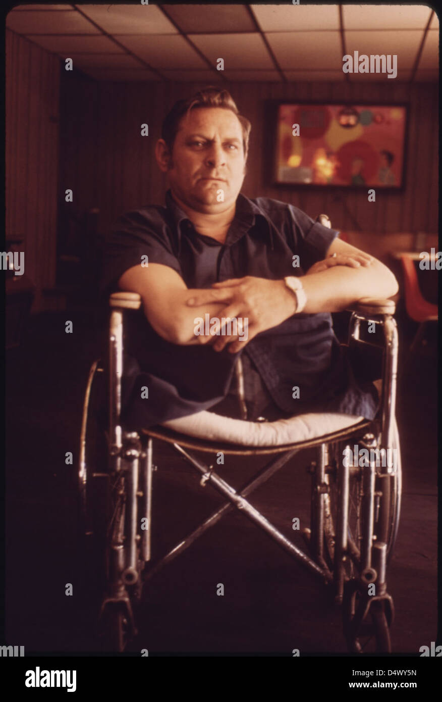 Jack Smith, 42, Rhodell, West Virginia, Seated in the Beer Joint He Operates in a Wheel-Chair Bought for Him by His Friend Arnold Miller, President of the United Mine Workers Union...04/1974 Stock Photo