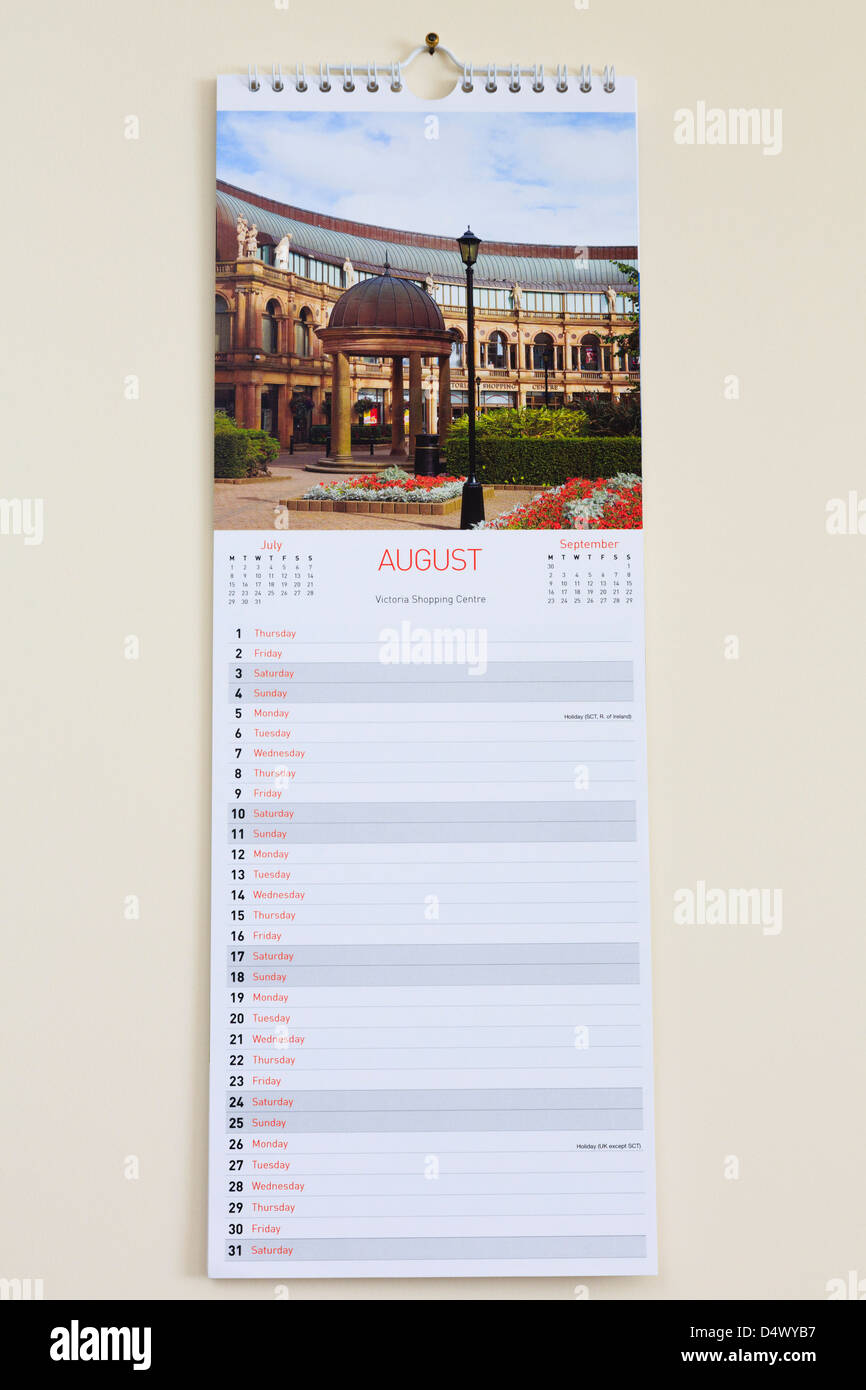 Blank pictorial calendar with photograph of Harrogate showing days and dates for month of August 2013 hanging on a wall Stock Photo