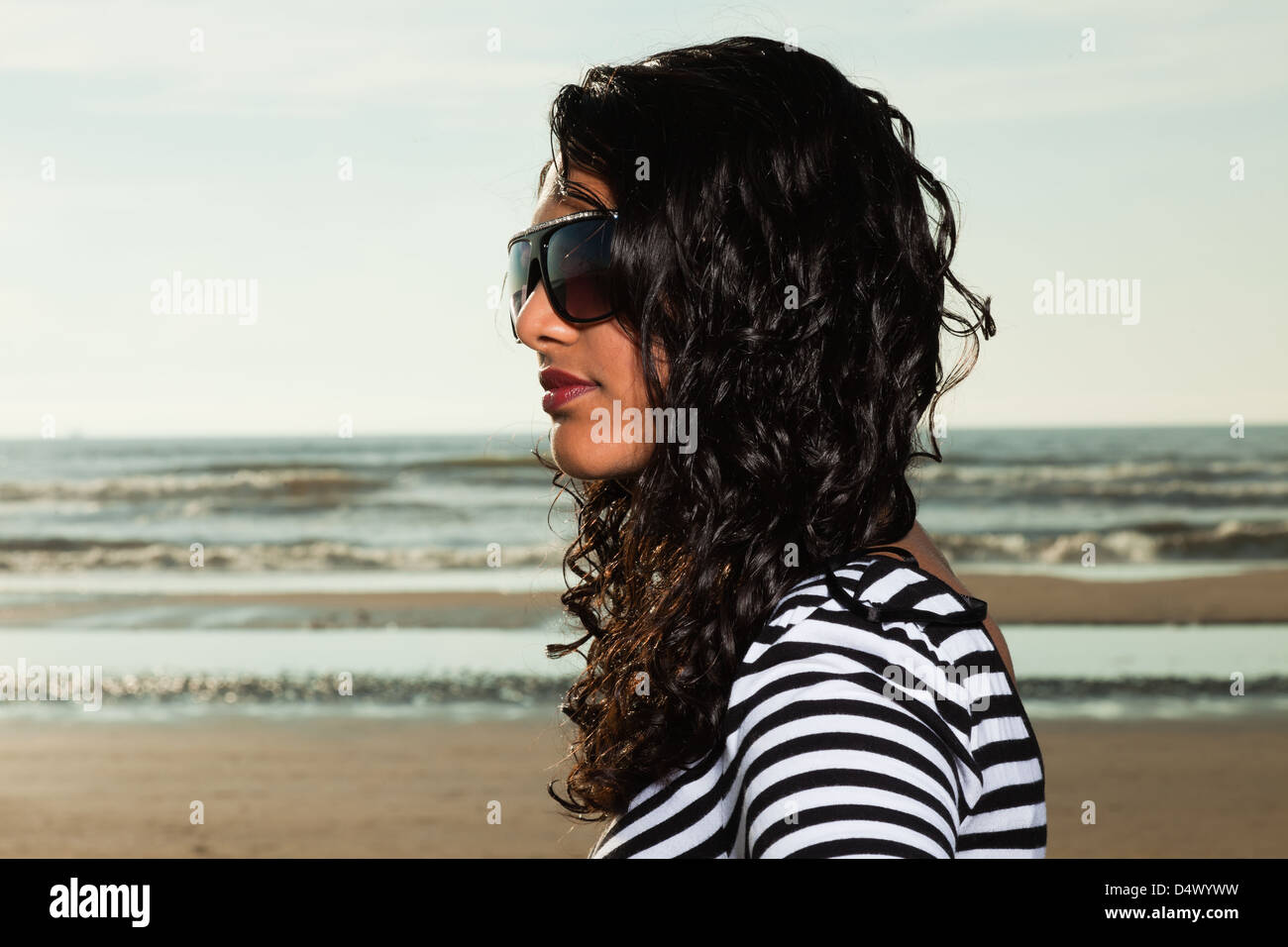 Pretty indian girl with sunglasses on the beach in summer Stock Photo ...
