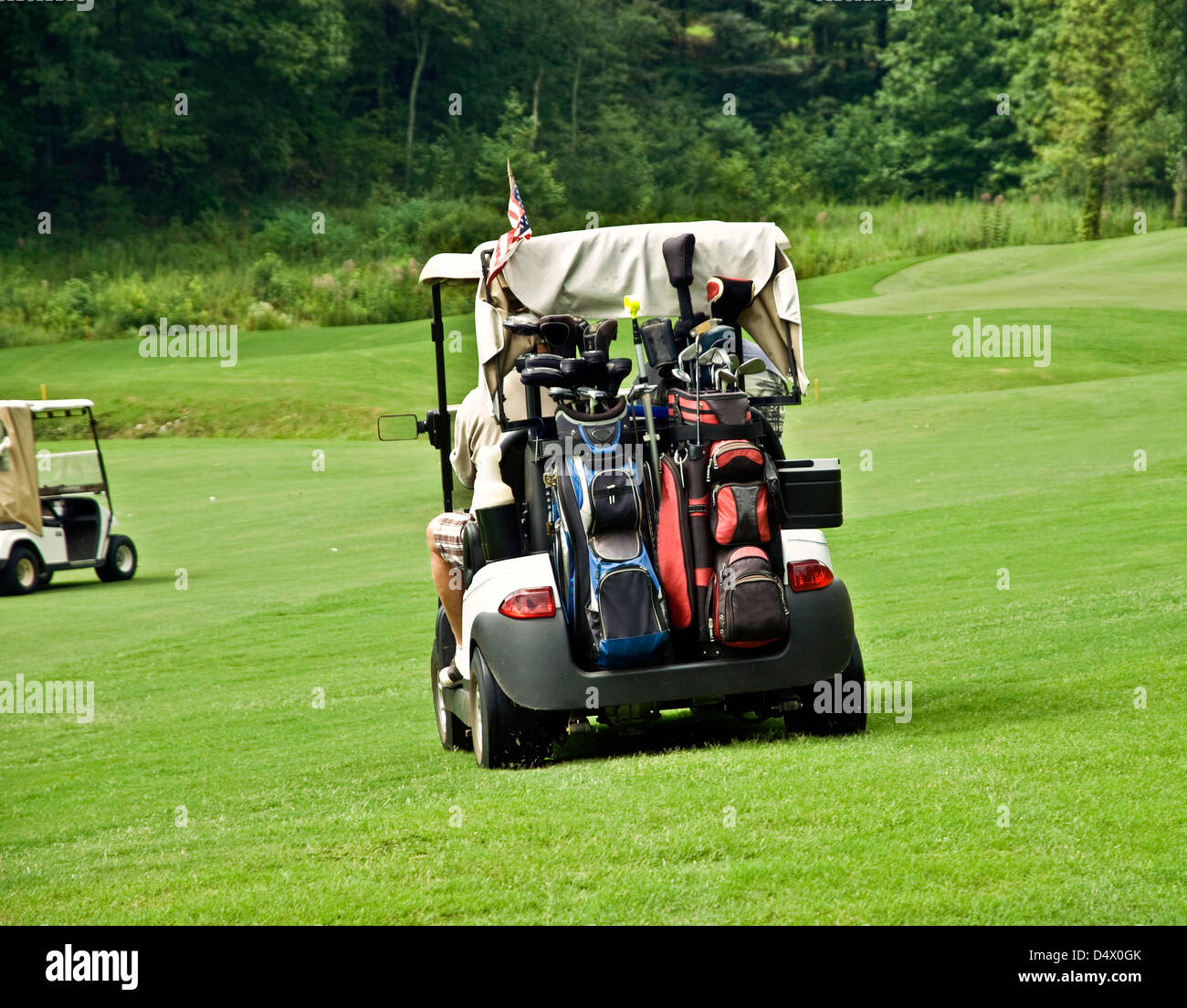 Golfers in carts driving to their balls Stock Photo Alamy