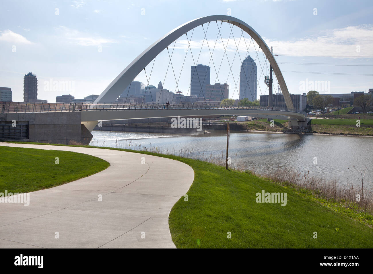 A bridge over a river with the Des Moines skyline in the backdrop, Iowa