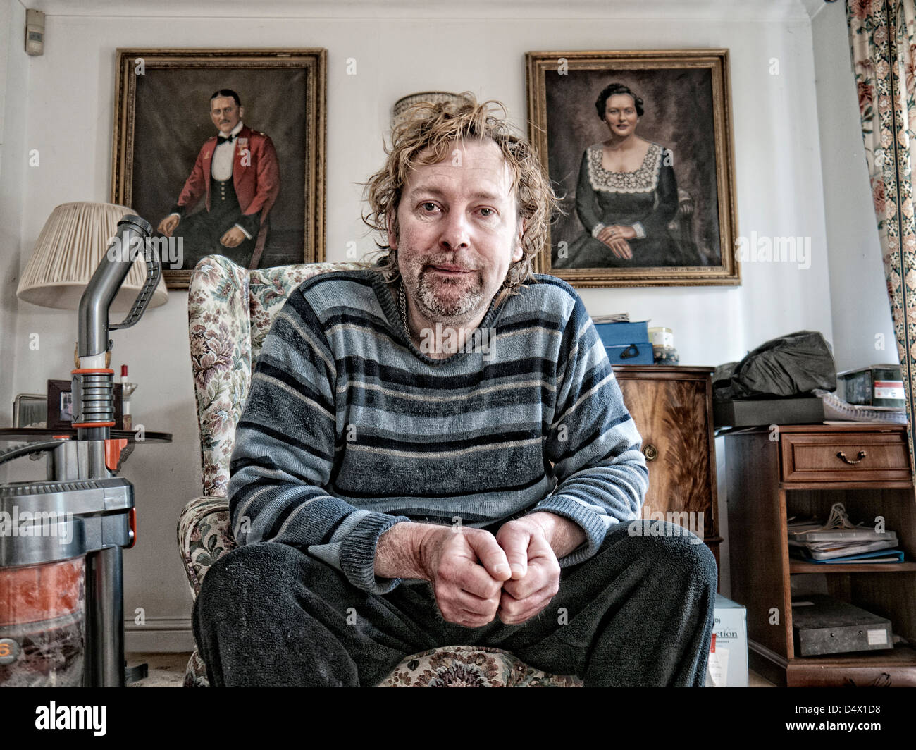 Portrait of a scruffy middle aged man in a middle class drawing room Stock Photo
