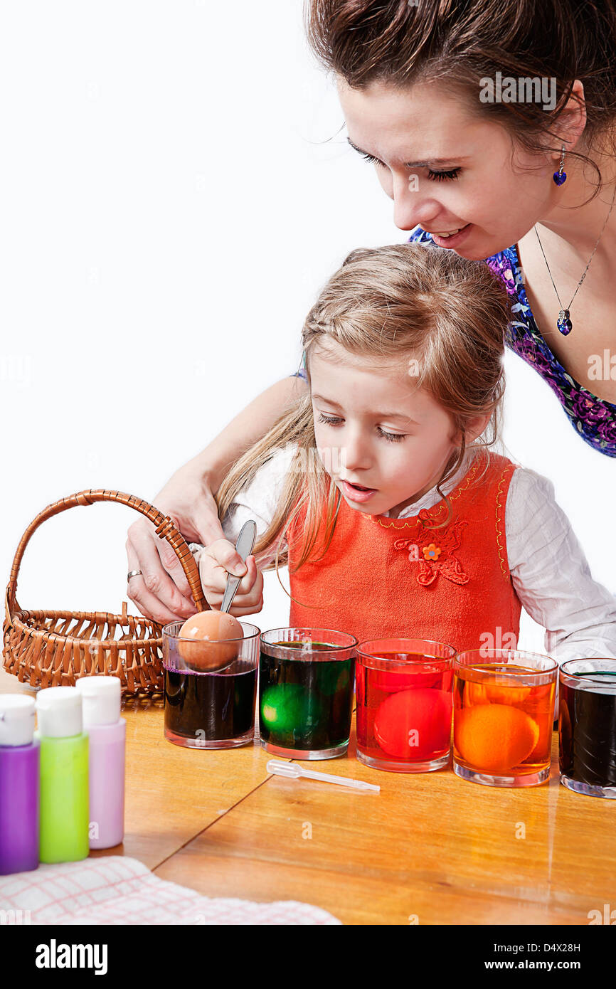 mum with daughter painting easter eggs Stock Photo