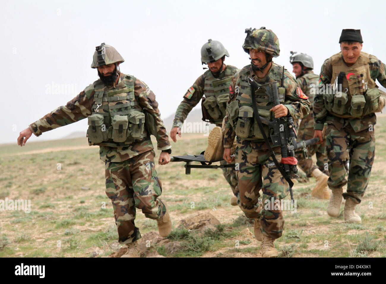 Afghan Commandos with Special Operations Kandak carry a simulated casualty during a live fire exercises March 18, 2013 in Herat province, Afghanistan. Stock Photo