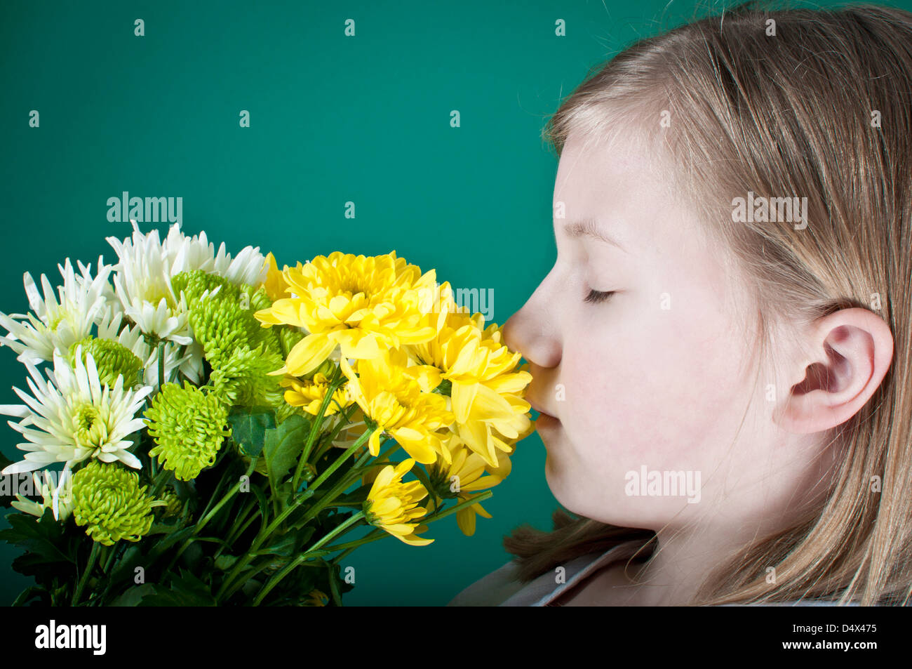 Girl smelling summer flowers Stock Photo - Alamy