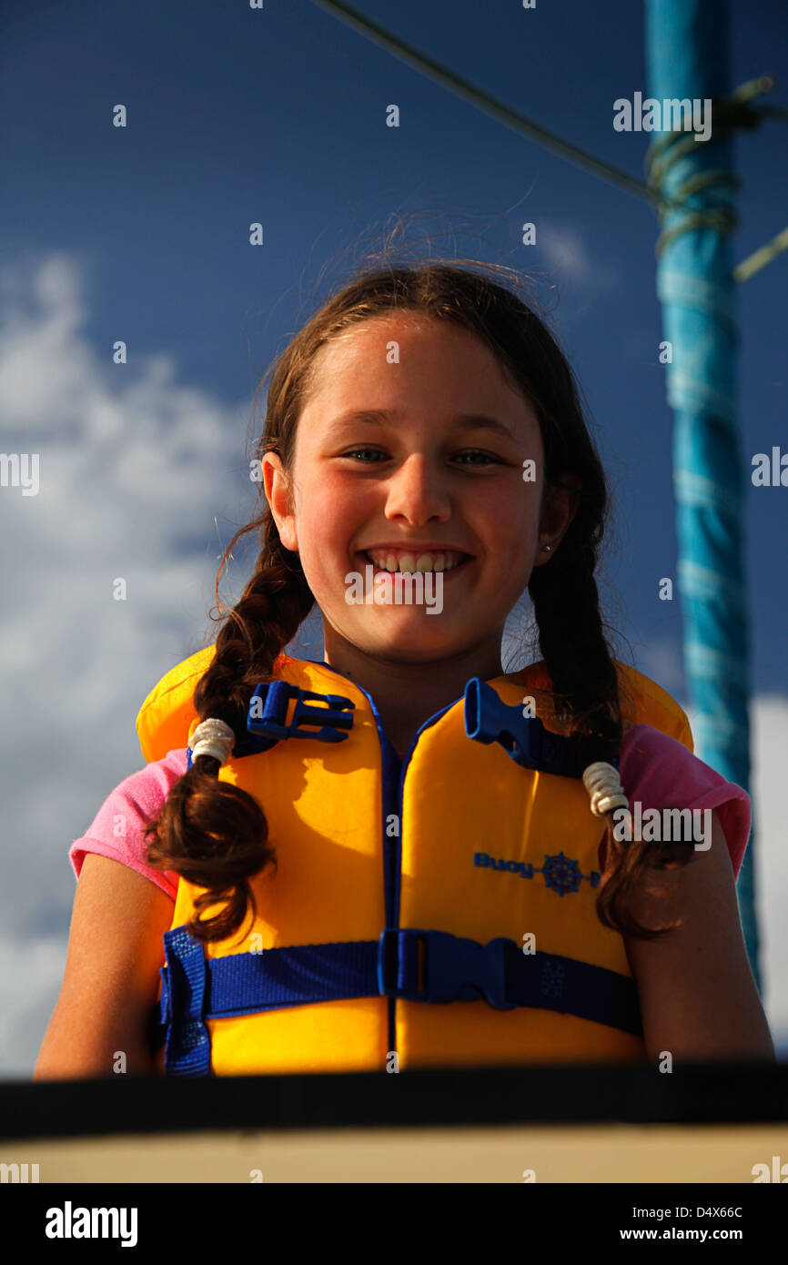 Schoolgirl wearing a life jacket on board a sailing boat in Ireland Stock Photo