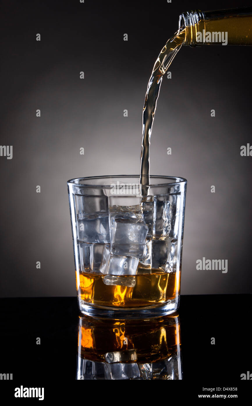 Pouring into empty glass. Stock Photo