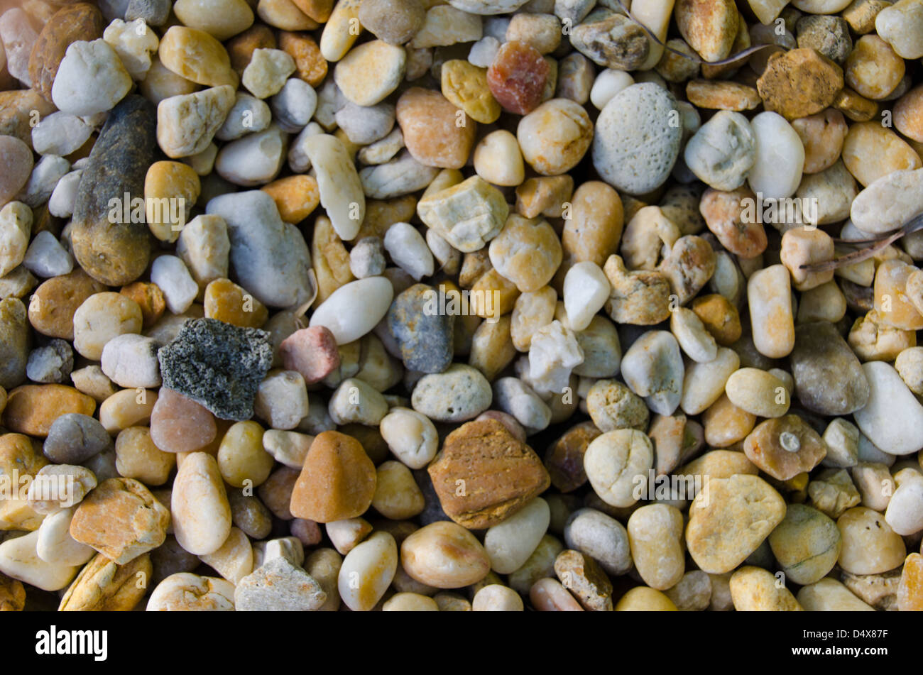 Natural background texture featuring the bright orange, white and brown rocks and pebbles of a landscaped Florida home Stock Photo