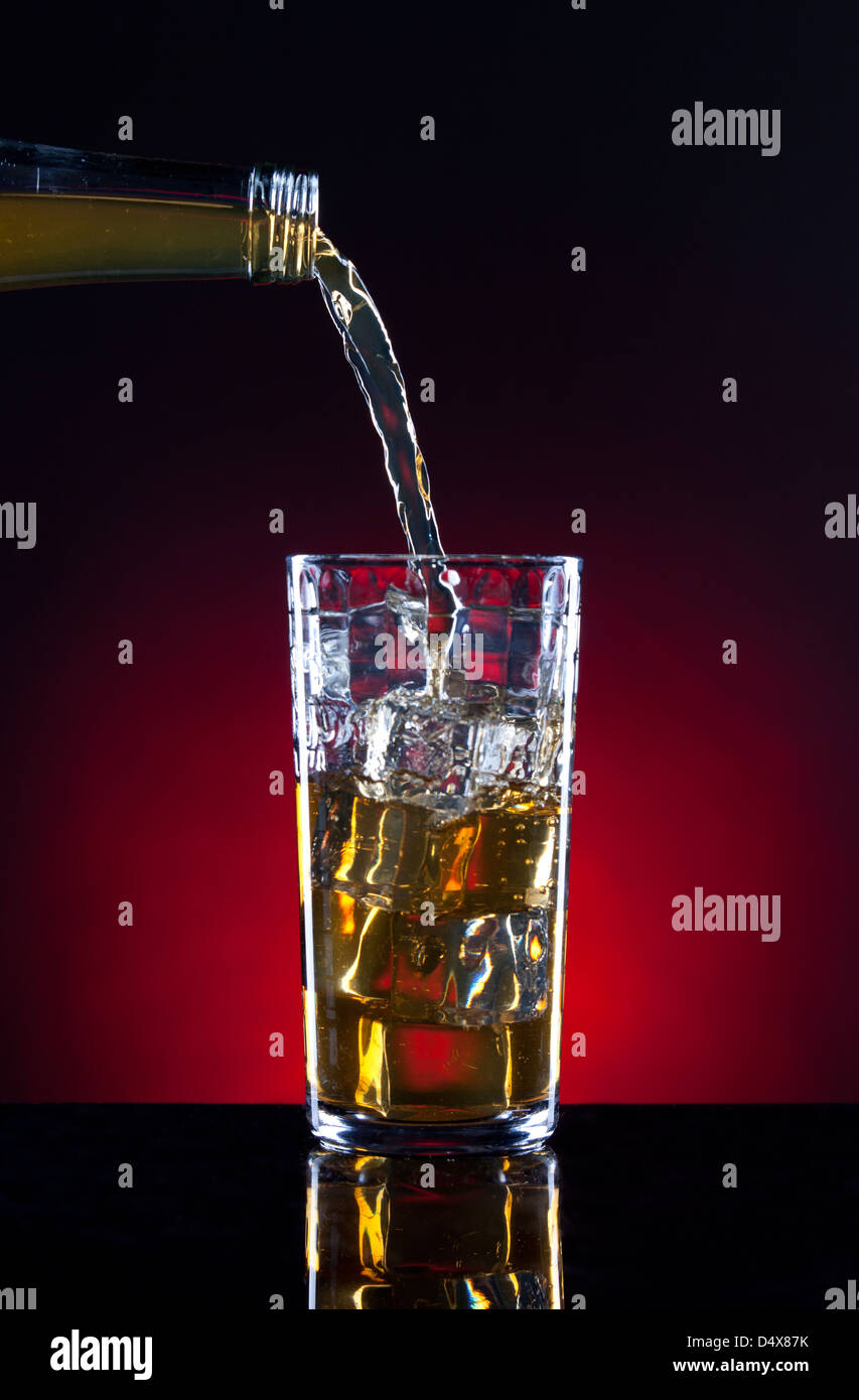 Serving up a glass of liquor. Stock Photo