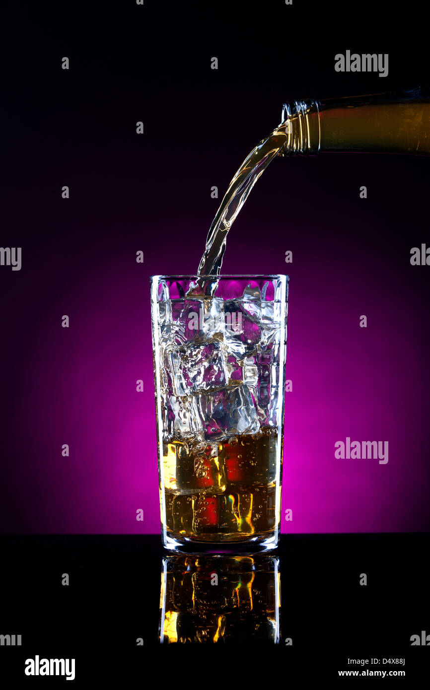 Pouring alcohol onto ice. Stock Photo
