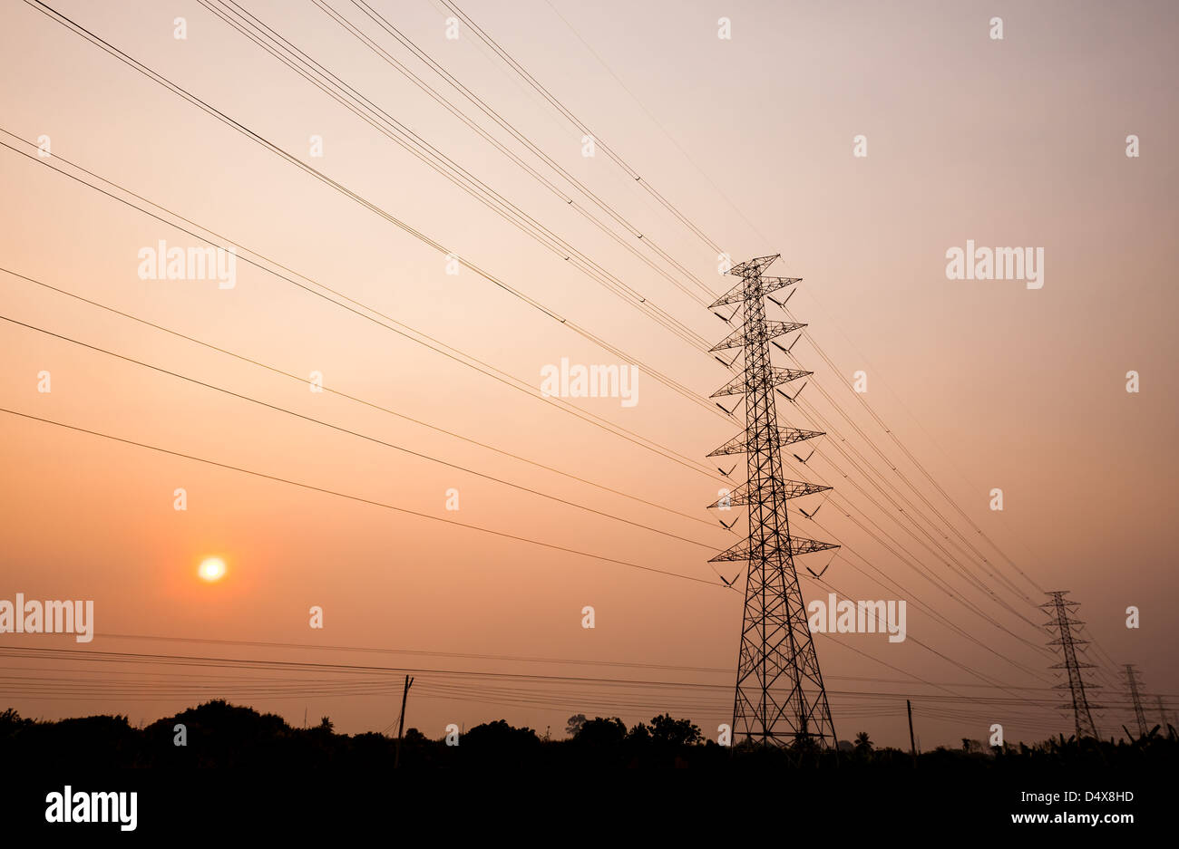 silhouette of power transmission towers with sunset in background Stock ...