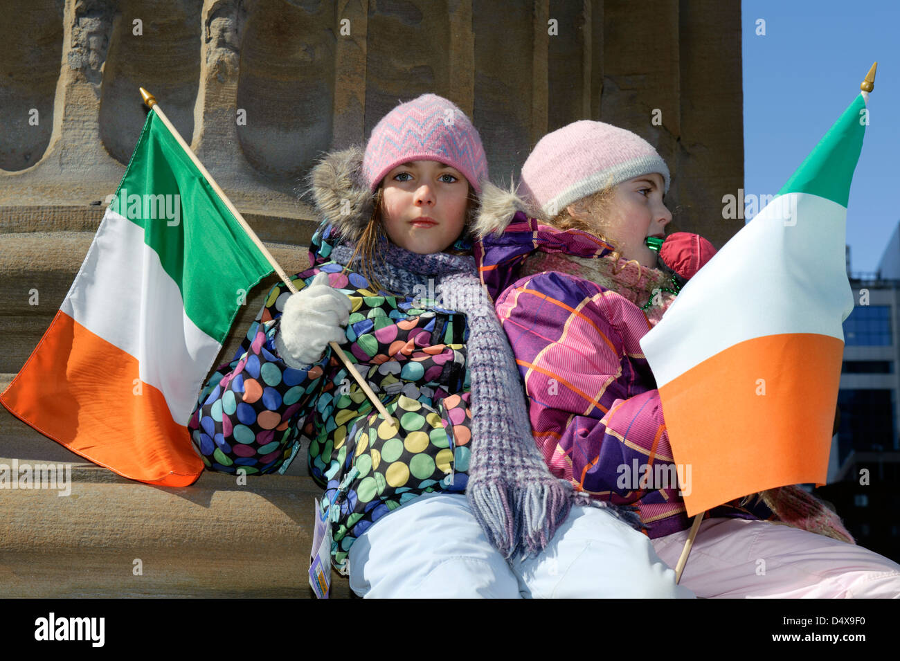 Two young girls with Irish flags attending the St Patrick's day parade in Montreal, province of Quebec, Canada. Stock Photo