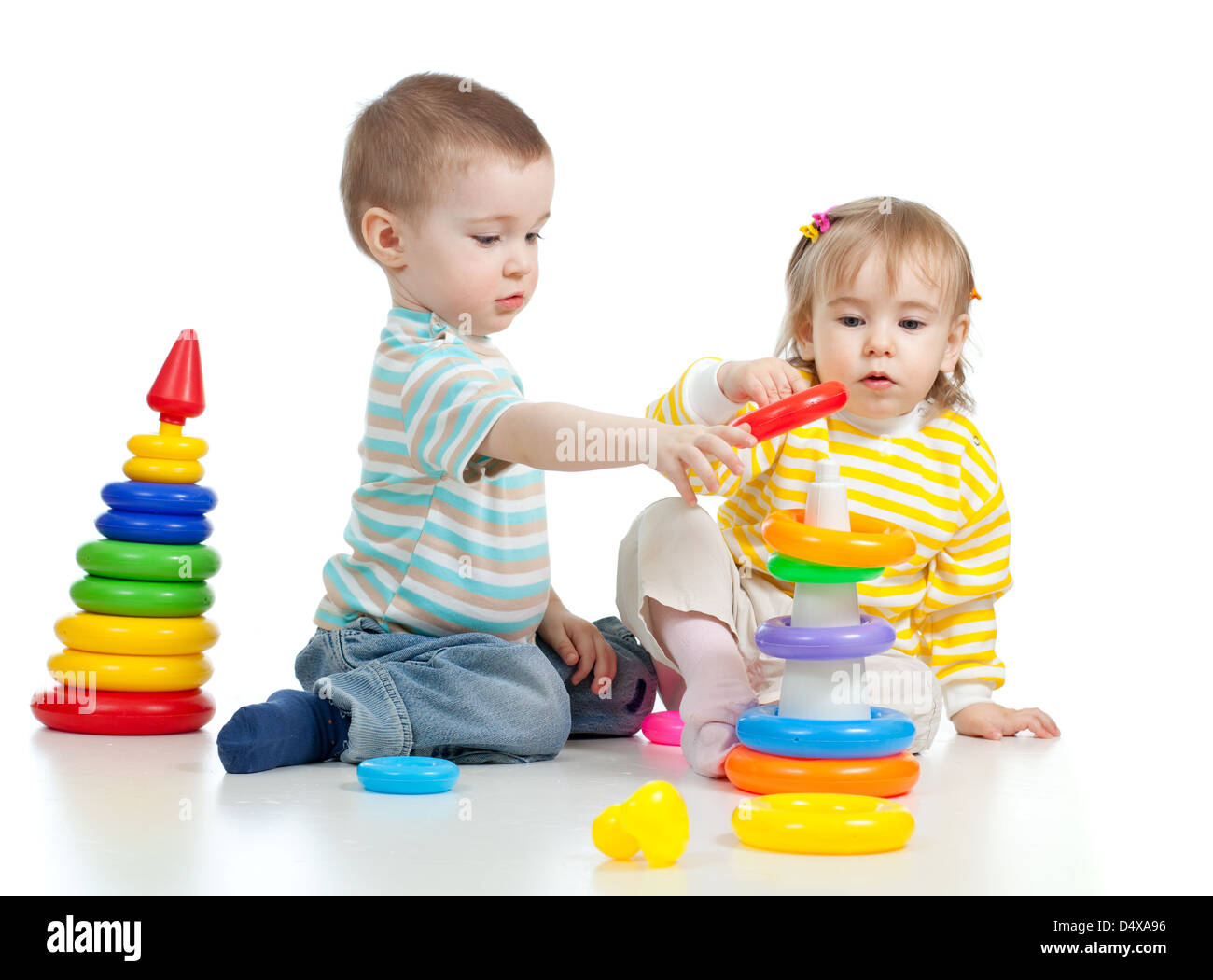 two little children playing with color toys Stock Photo - Alamy