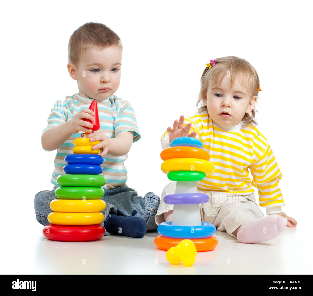 two little children playing with color toys Stock Photo - Alamy