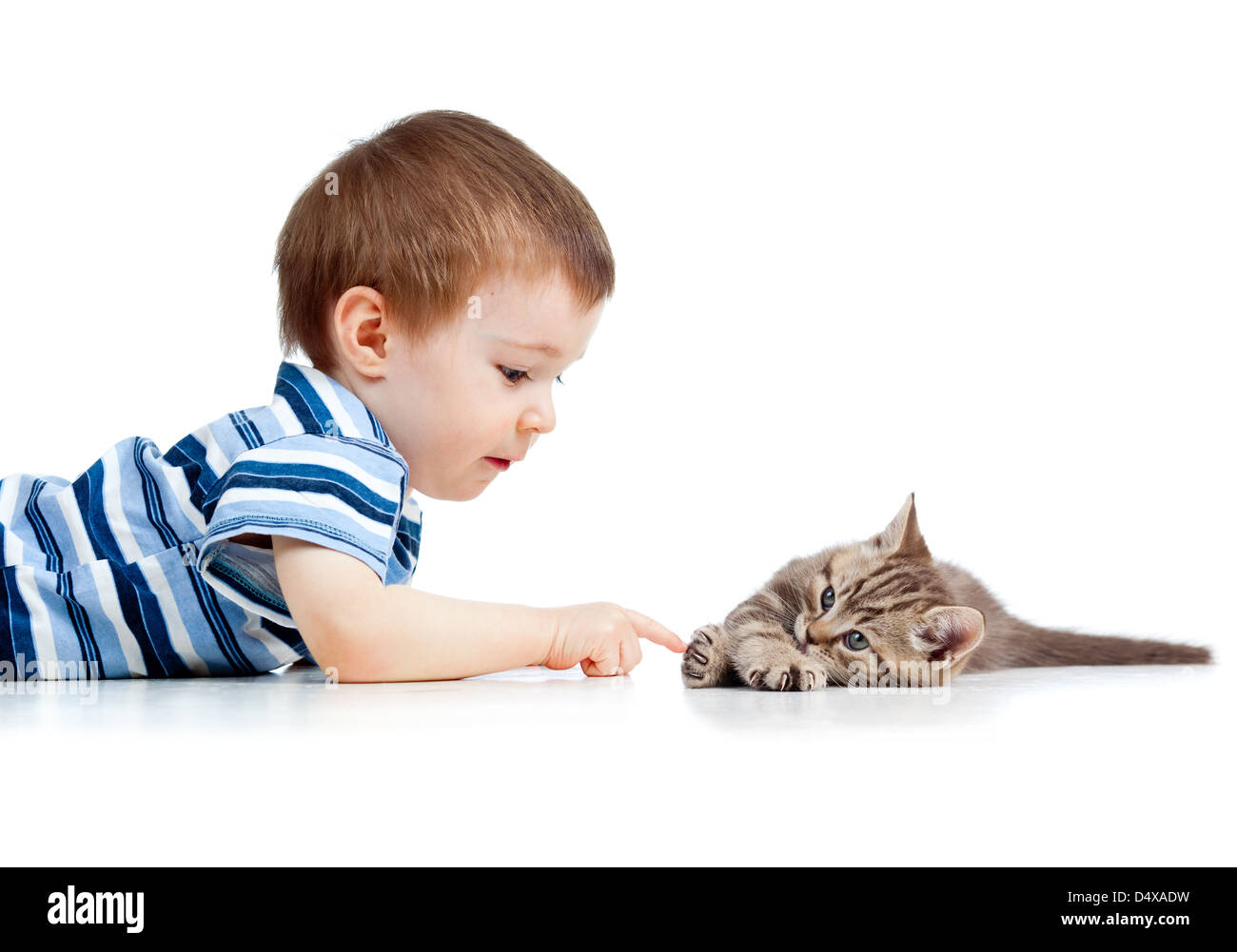 cute kid lying on floor and playing with cat pet Stock Photo