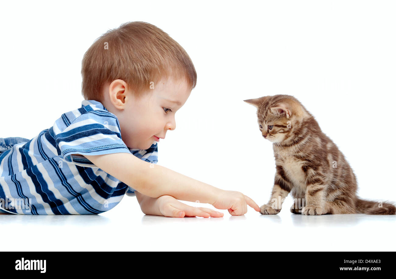 cute kid lying on floor and playing with cat pet Stock Photo