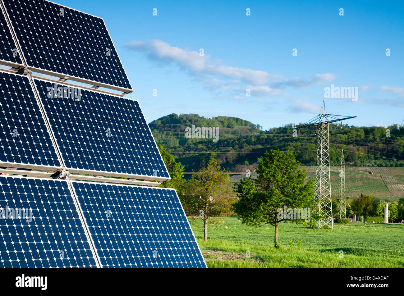 Solar Panel With Green Landscape Against The Blue Sky Stock Photo
