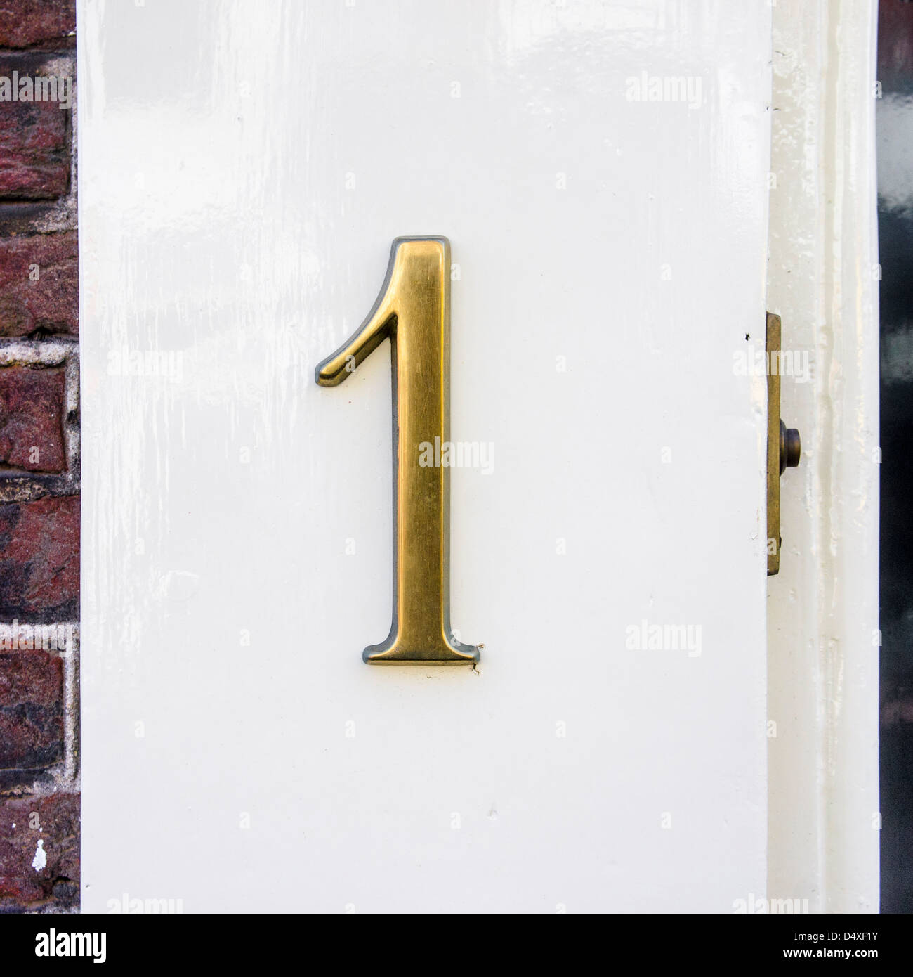 cast bronze house number one next to a door bell Stock Photo Alamy