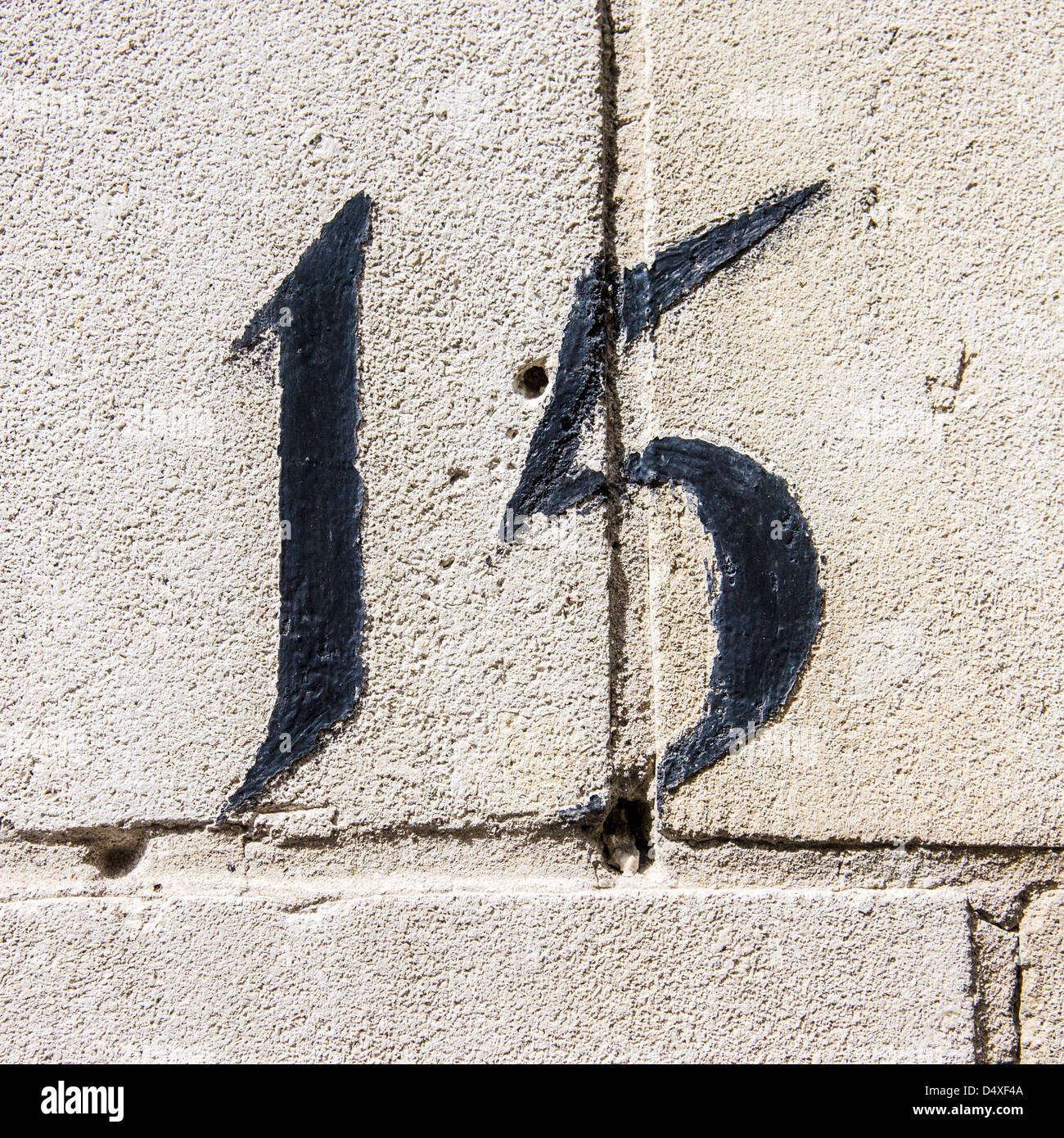 house number fifteen , painted on aerated concrete. Stock Photo