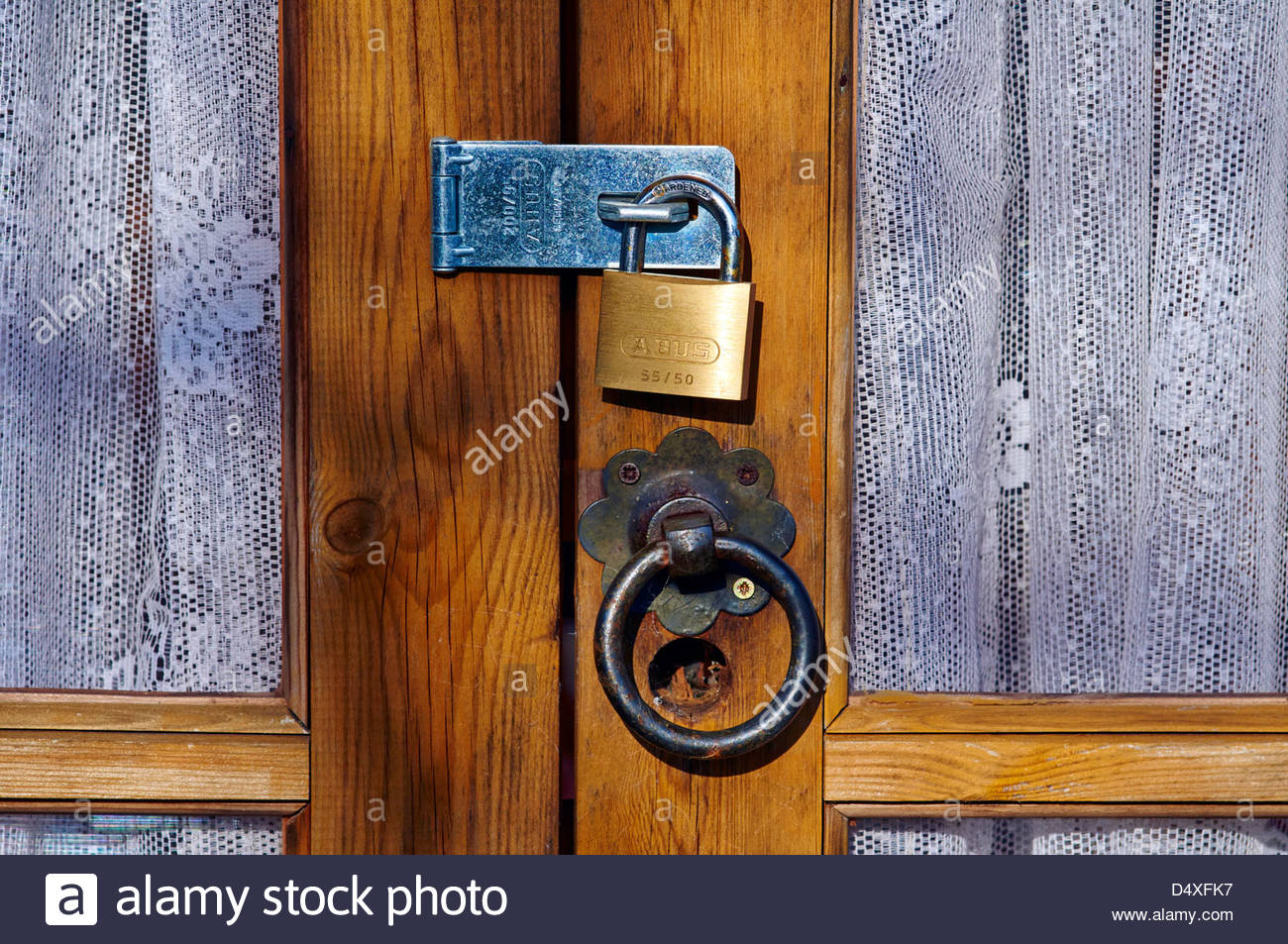 Brass Padlock Steel Lock On A Wooden Door With Glass Panels