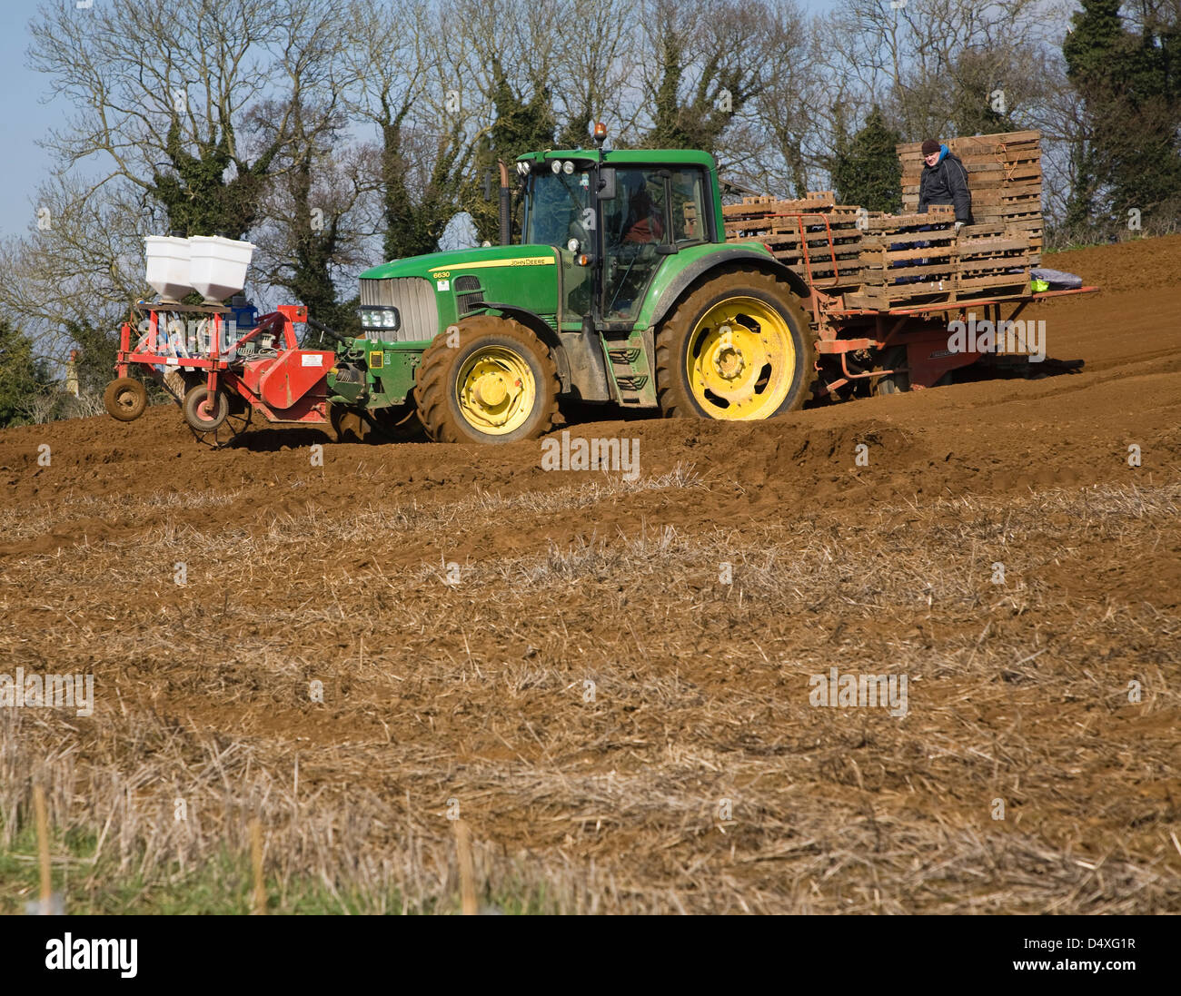 Farm machinery planting a crop of potatoes in a field, Shottisham, Suffolk, England Stock Photo
