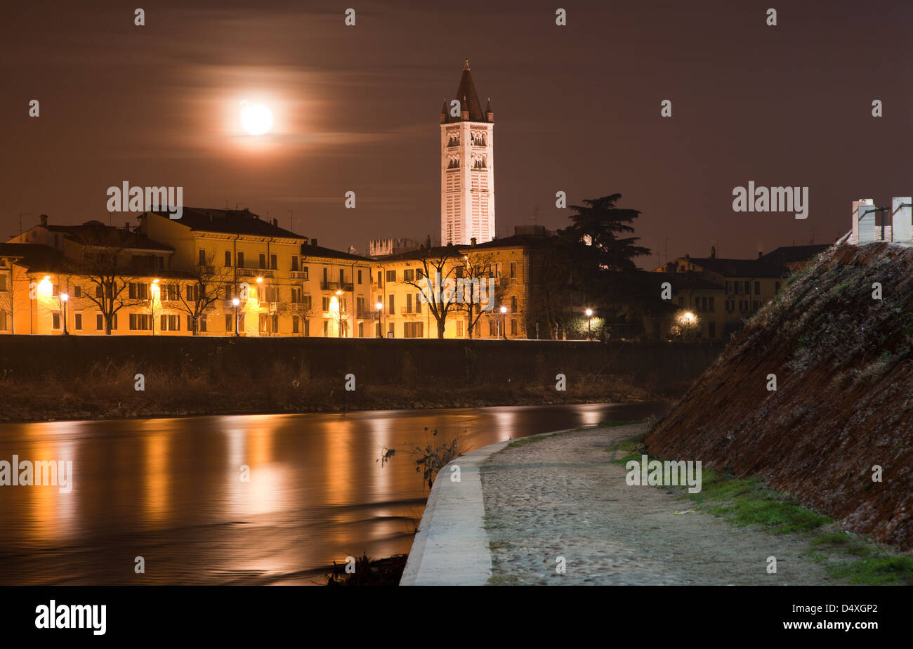 Verona - Adige river waterfronat and tower of San Zeno church at night Stock Photo