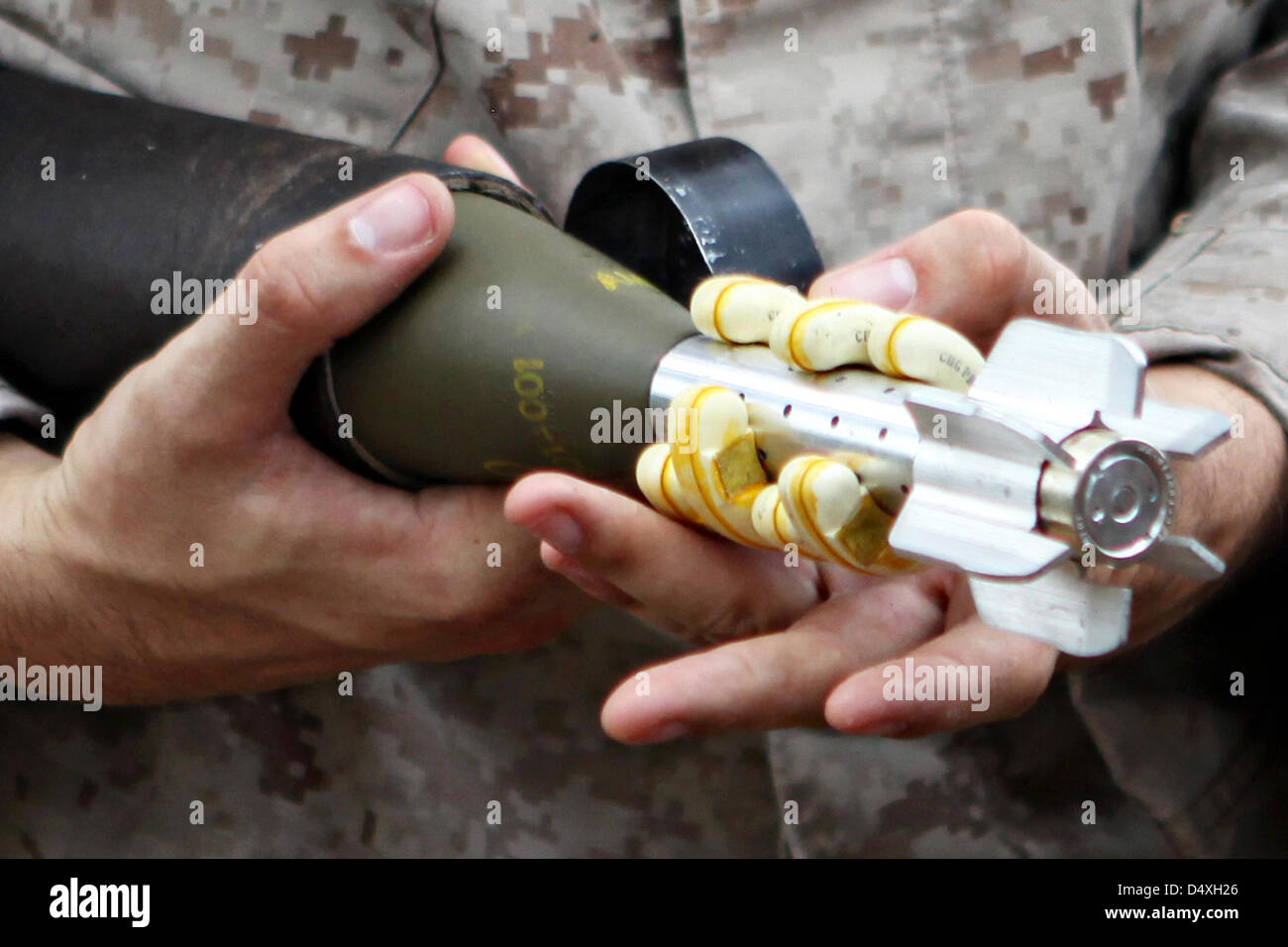 A US Marine holds a 60 mm mortar rounds from M224 Mortar Systems