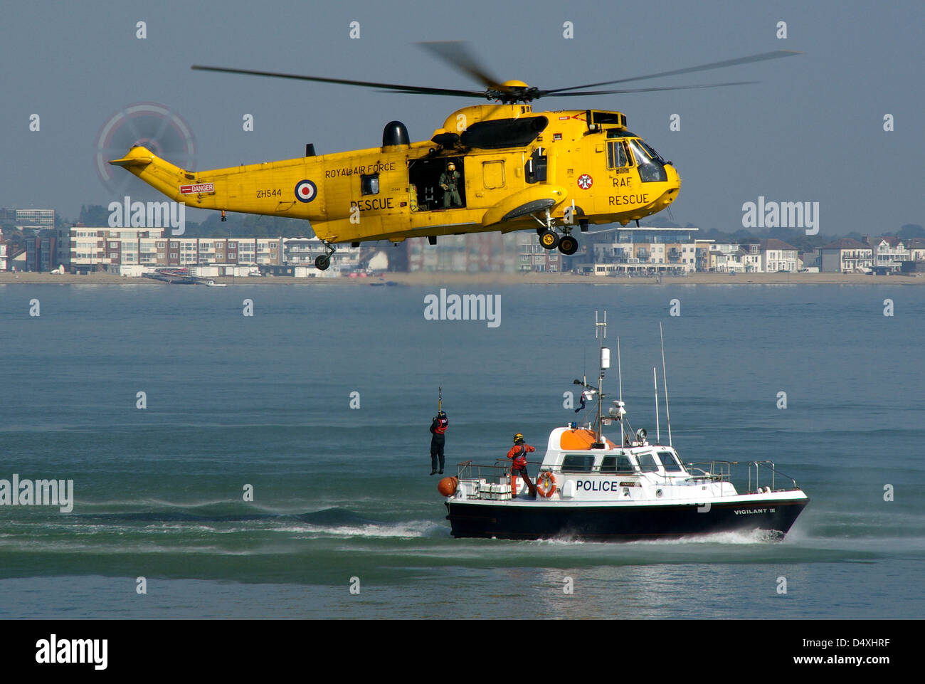 A practice rescue scenario carried out at Southend on sea by an RAF Search & Rescue Sea King serial ZH544 and a Police launch Stock Photo