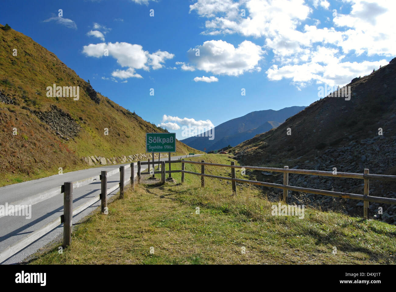 Solkpass mountain pass with road, peaks, meadow and blue sky with clouds in Niedere (Lowerú Tauern mountains in Austria Stock Photo