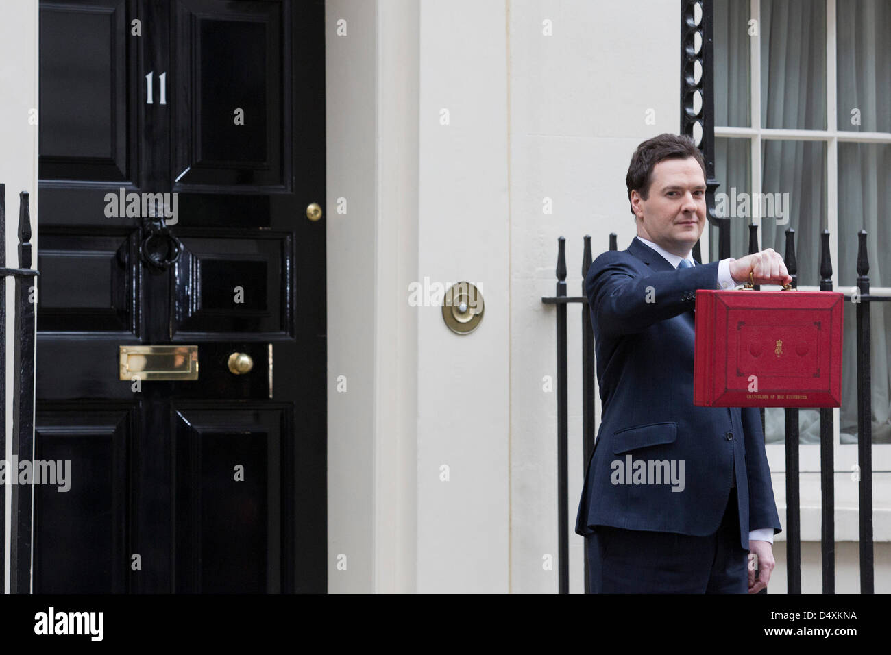 Wednesday, 20 March 2013, London, UK. George Osborne, Chancellor Of The Exchequer, holds his red ministerial despatch box outside 11 Downing Street In London, before the presentation of the annual budget in Parliament. Credit: Nick Savage/Alamy Live News Stock Photo