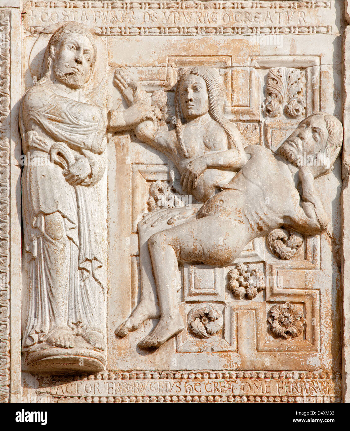 VERONA - JANUARY 27: Relief of creation of woman facade of romanesque Basilica San Zeno. Stock Photo