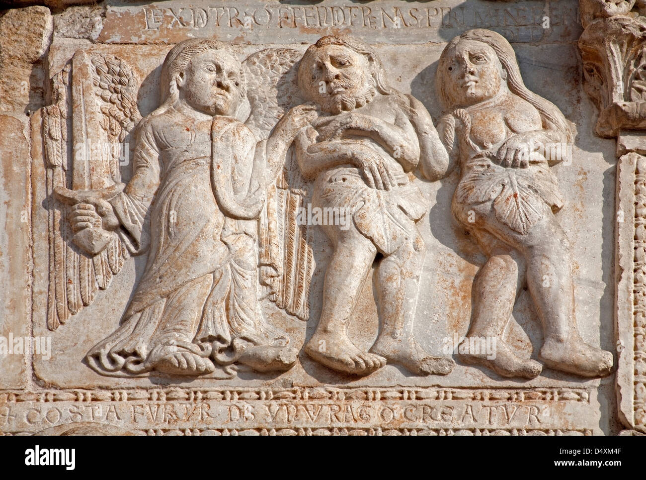 VERONA - JANUARY 27: Expulsion of Adam and Eva from Paradise facade of romanesque Basilica San Zeno Stock Photo